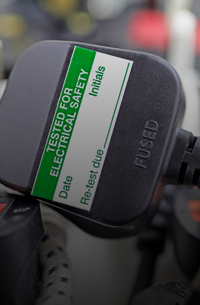 Electrical safety tag on black plug