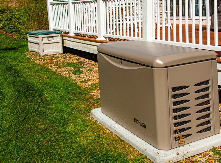 Standby generator near wooden deck