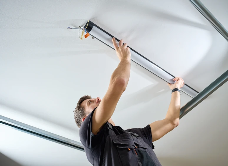 Technician working on ceiling lamp installation