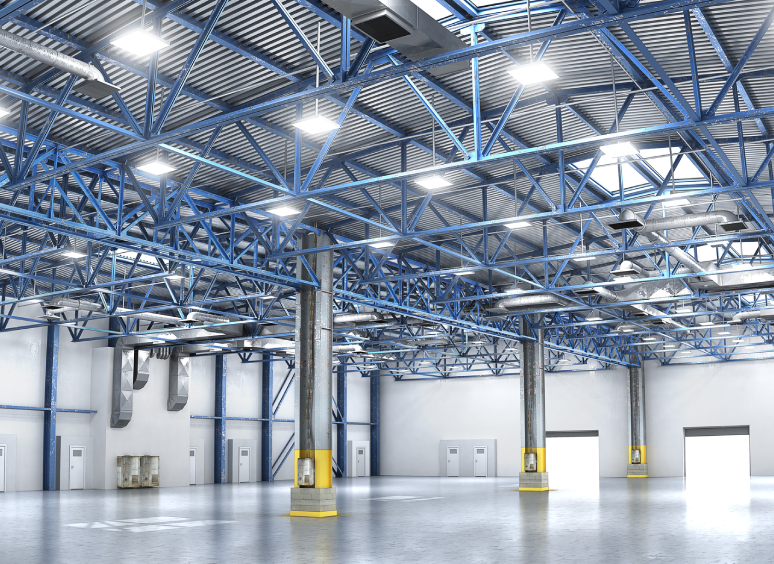 Empty warehouse with high ceilings and lights.