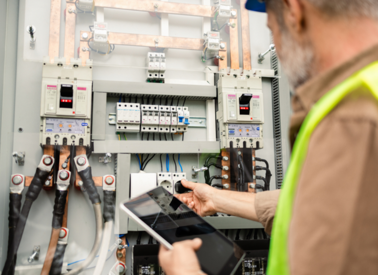 Technician checking electrical panel connections