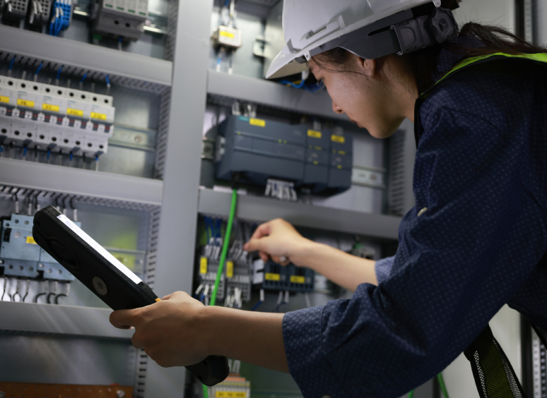 Engineer working on industrial control panel