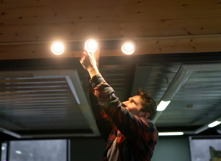 Man fixing ceiling lights