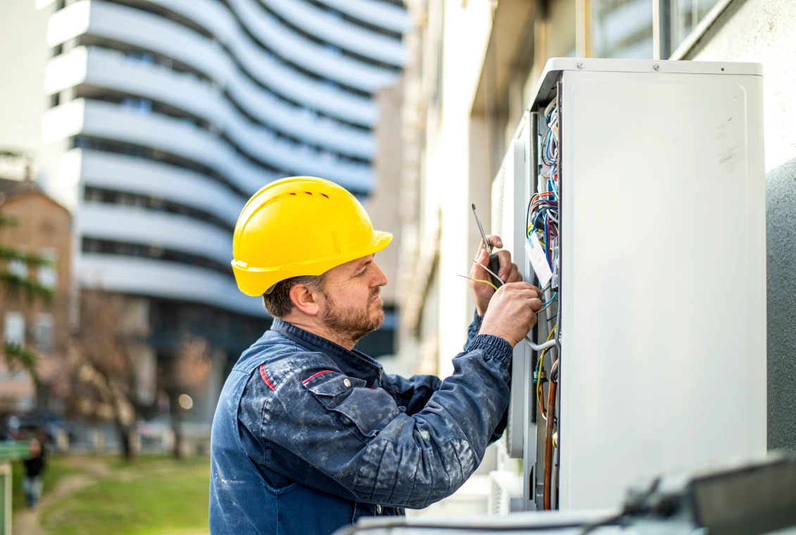 Electrician working on outdoor electrical box