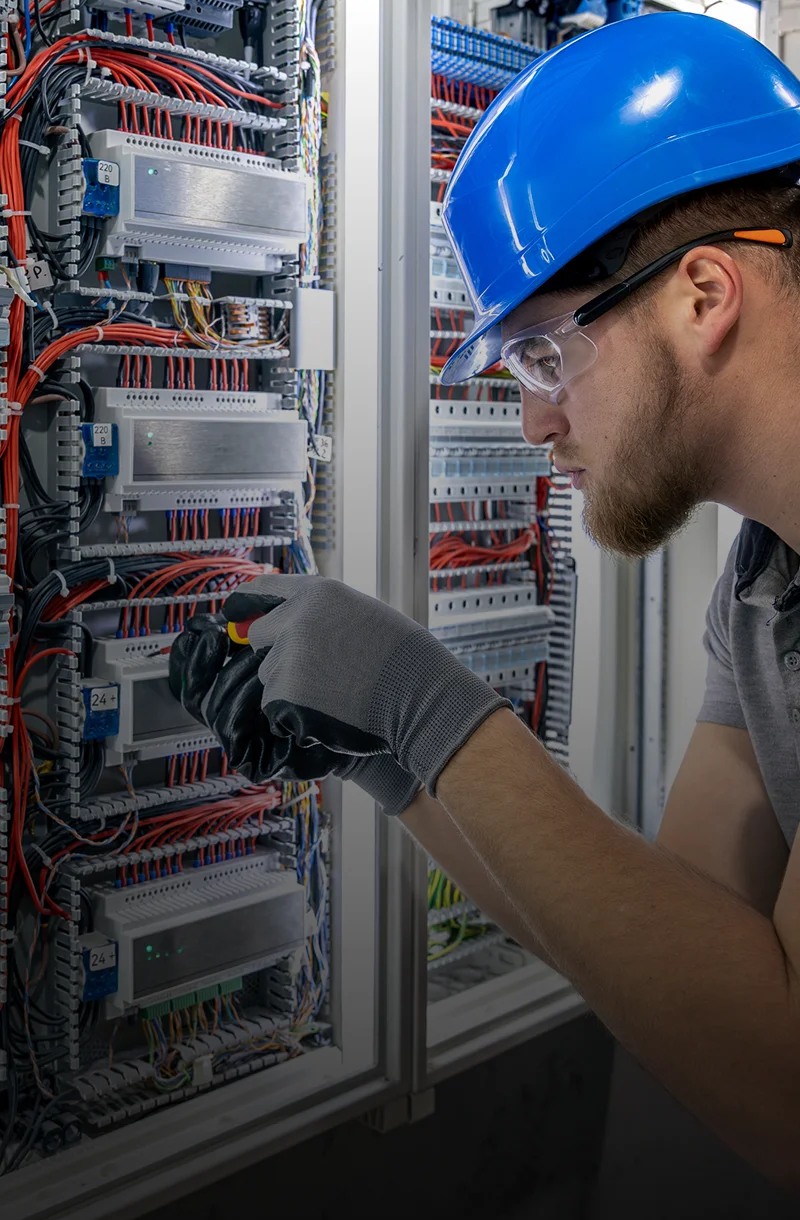 Technician adjusting electrical components